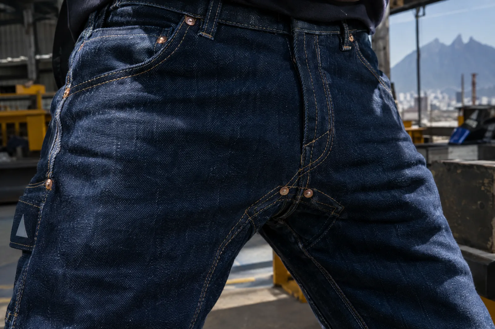 Tiro de un pantalón de mezclilla con costura doble y remaches de refuerzo